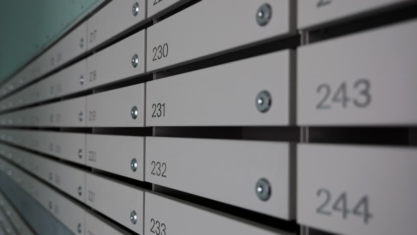 Row of Numbered Mailboxes in Apartment Building