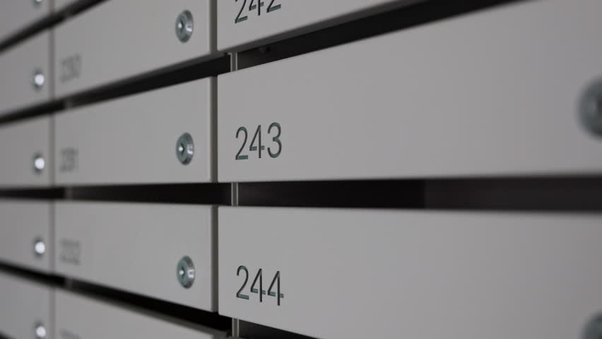 Numbered Apartment Mailboxes in Residential Building Hallway