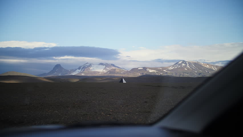 Driving Through Iceland Highlands with Volcanic Mountains