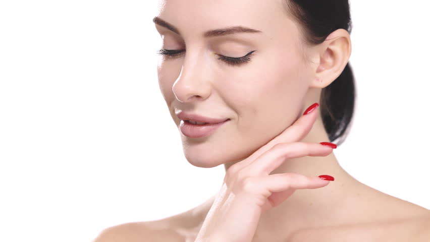 Young woman with radiant smooth facial skin posing isolated on white background. Cosmetology concept.
