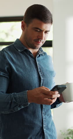 Man, coffee and reading with phone in home for games, browsing website and texting. Male person, typing and beverage with mobile for streaming movies, social media and notification for message update