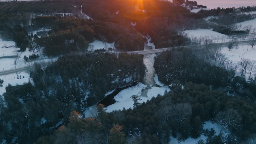 Sunset over snowy Elora Gorge in Elora, Ontario, peaceful winter scene
