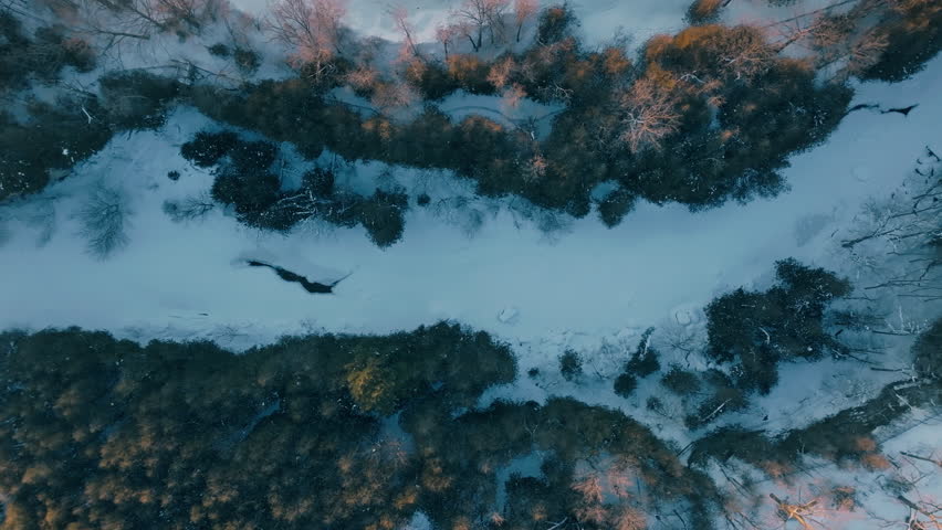 Snowy aerial view of Elora Gorge in winter, showcasing tranquil beauty