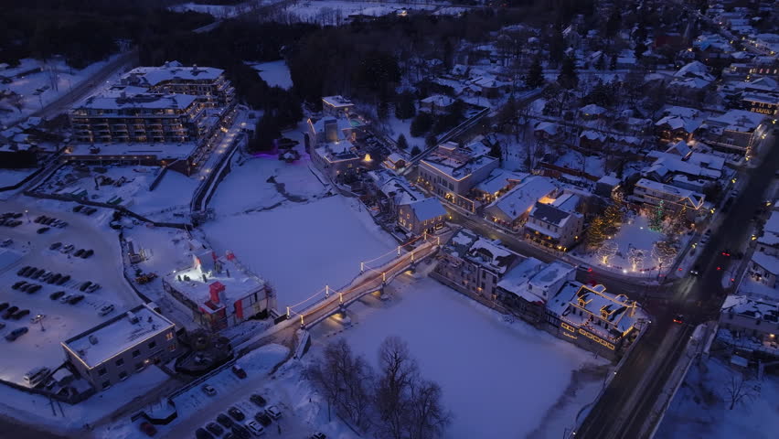 Elora town at night with snowy bridge view of frozen Grand River