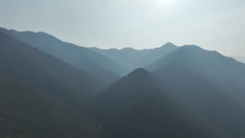 Aerial drone shot of a resilient pine tree growing on a steep, rocky cliff in Mungyeong, South Korea