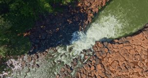 Aerial view of Tad Pha Suam Waterfall near Pakse in Champasak Southern Laos. Water flows over unique column like rock formations surrounded by lush tropical forest, creating a scenic natural - Powered by Shutterstock - Get 15% off with code: PIKWIZARD15
