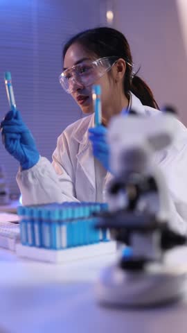 Scientists are analyzing liquid in a test tube in the laboratory.