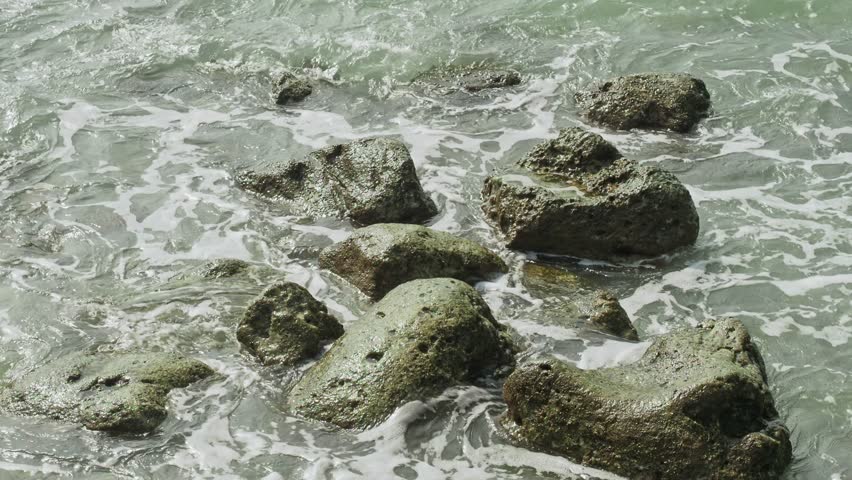 Ocean waves over small rocks