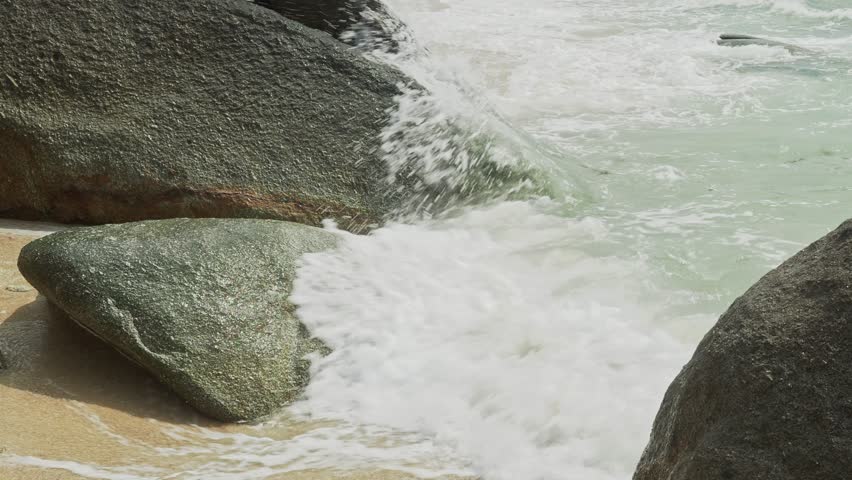Ocean waves over big rocks