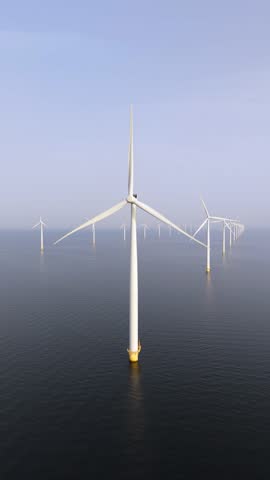 Giant wind turbines stand tall in the Atlantic Ocean, harnessing wind energy to produce sustainable electricity. This offshore wind farm showcases innovation and eco-friendly technology in action.