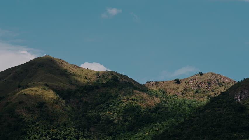 Timelapse of weather change in high mountains. 
The clouds move very fast and cast shadows on the 
beautiful mountains. The day turns into evening. Power of nature