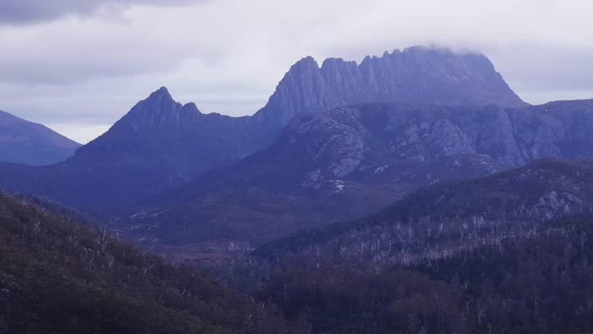 Scenic rocky peaks of Cradle mountain in Tasmania national park at sunset – aerial view.