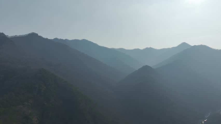 Aerial drone shot of a resilient pine tree growing on a steep, rocky cliff in Mungyeong, South Korea