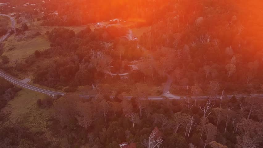Lift to setting sun in Cradle Mountain national park of Tasmania, Australia – aerial 4k.