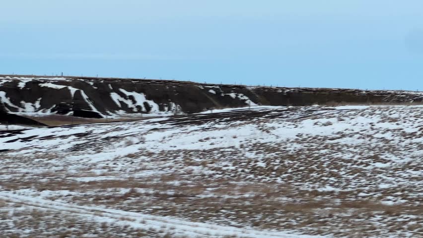 Wide open farmland with prairie grass and expansive sky creating natural landscape background