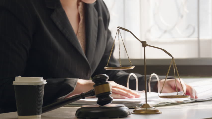 Judge gavel and computer keyboard on office desk representing legal technology and digital justice system concept.