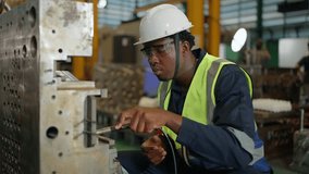 Focused Industrial Technician at Work: An industrial technician, equipped with protective eyewear and a safety helmet, meticulously works on machinery, emphasizing precision and expertise. - Powered by Shutterstock - Get 15% off with code: PIKWIZARD15