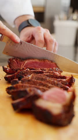 Vertical Close Up Hands Slicing Grilled Red Meat With Knife, Barbecue Steak Cutting