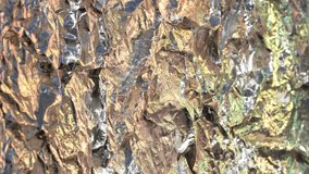 Crumpled aluminum foil surface reflecting metallic colors and abstract light textures - Powered by Shutterstock - Get 15% off with code: PIKWIZARD15