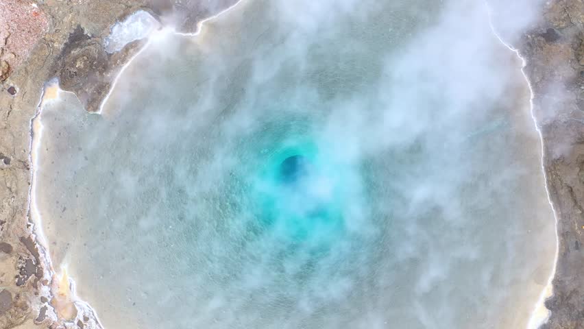 Flying above the Great Geyser, geysir in the Golden Circle, Iceland, slow motion aerial view