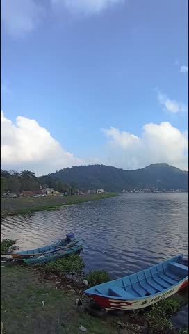 A peaceful lake view with a drifting boat.