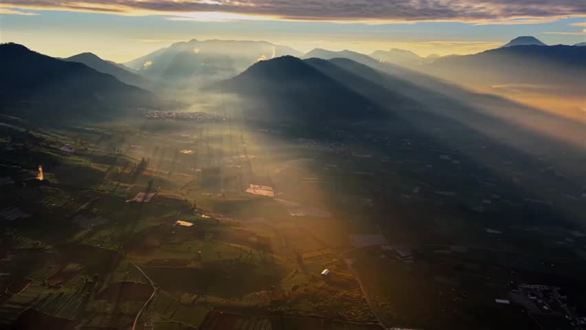 Golden Sunrise Rays Over Mountain Valley Village