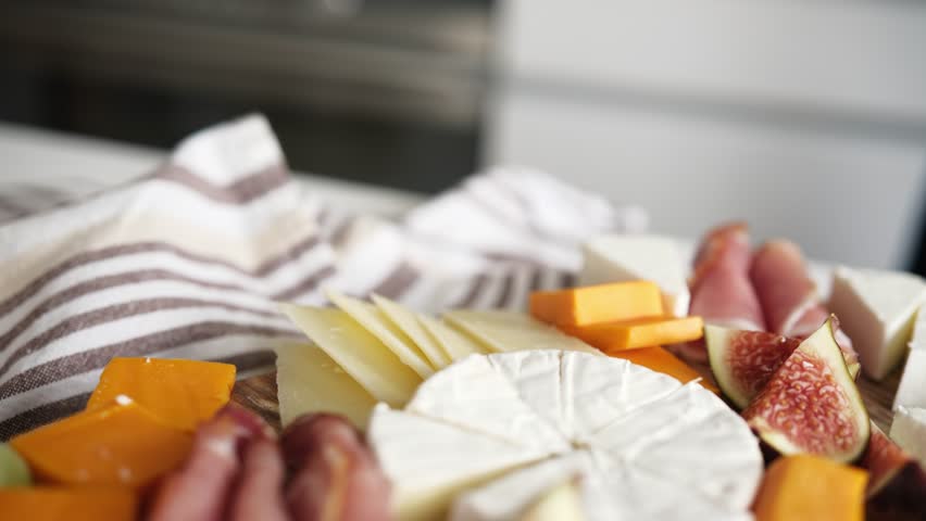 Cheese Board With Fruits And Ham On A Table As Charcuterie Board For Party