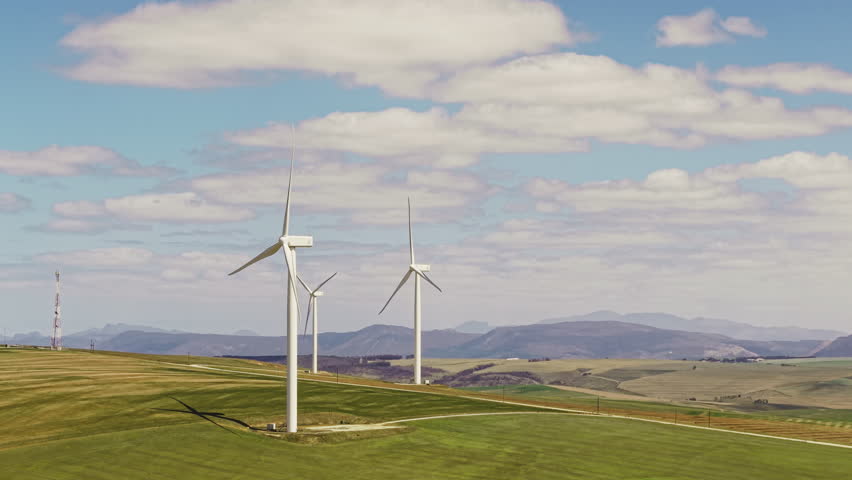 Wind turbine, power or grass field with blue sky for renewable energy or economic development. Windmill, outdoor sustainability or eco friendly environment with natural alternative resource on space
