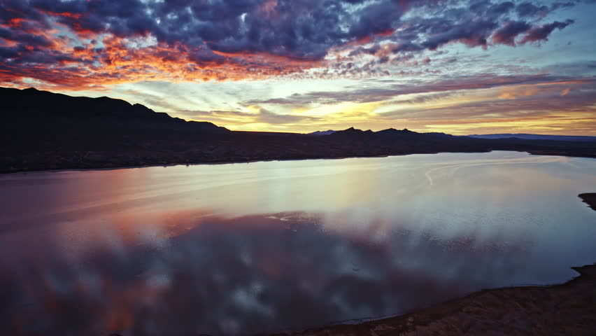 Cinematic drone shot of sunrise colors over Caballo Lake State Park in New Mexico