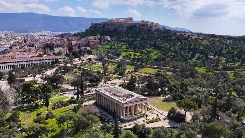 Aerial drone cinematic video of iconic Temple of Hephaestus in Ancient Agora of Athens historic centre built below Acropolis hill , Attica, Greece