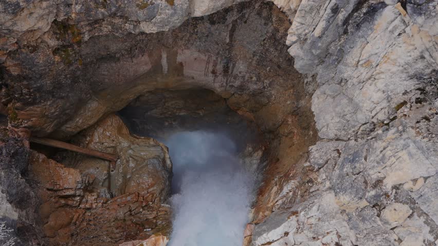 Powerful waterfall plunging into a narrow entrance in Marble canyon in Kootenay National Park