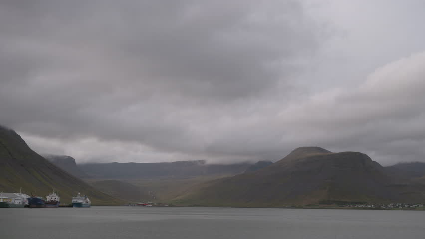 Isafjordur, Iceland fjord, mountains, and harbor on an overcast day