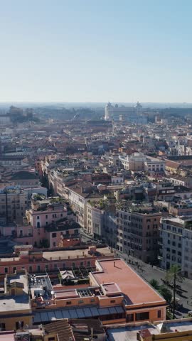 Vertical Drone View of Rome Historic Cityscape under Clear Blue Sky in Italy. Historic Landmarks from Above with Monument to Victor Emmanuel II.