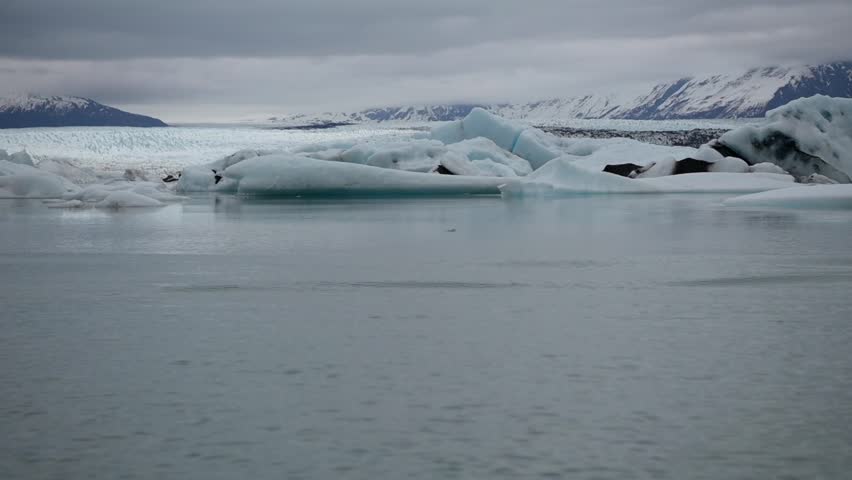 Cinematic handheld POV footage of a small boat navigating through ice chunks and icebergs on Matanuska Glacier in Alaska.  Ideal for dramatic, adventure, relaxing, travel, outdoor, and glacier-themed projects. 