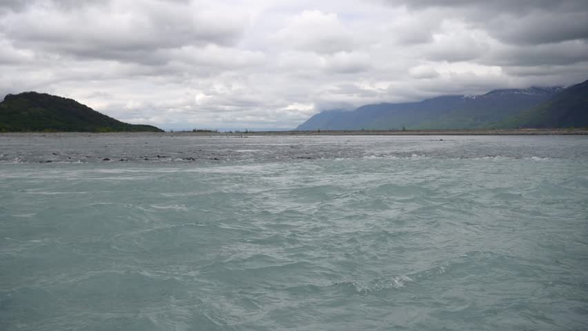 Cinematic handheld POV footage of a small boat navigating through ice chunks and icebergs on Matanuska Glacier in Alaska.  Ideal for dramatic, adventure, relaxing, travel, outdoor, and glacier-themed projects. 