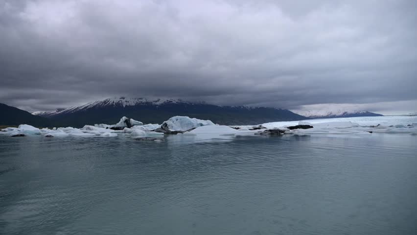 Cinematic handheld POV footage of a small boat navigating through ice chunks and icebergs on Matanuska Glacier in Alaska.  Ideal for dramatic, adventure, relaxing, travel, outdoor, and glacier-themed projects. 