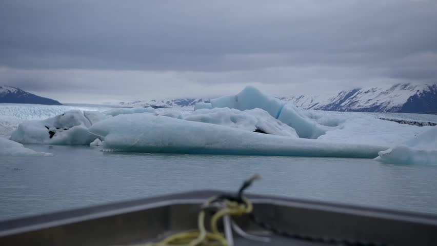 Cinematic handheld POV footage of a small boat navigating through ice chunks and icebergs on Matanuska Glacier in Alaska.  Ideal for dramatic, adventure, relaxing, travel, outdoor, and glacier-themed projects. 