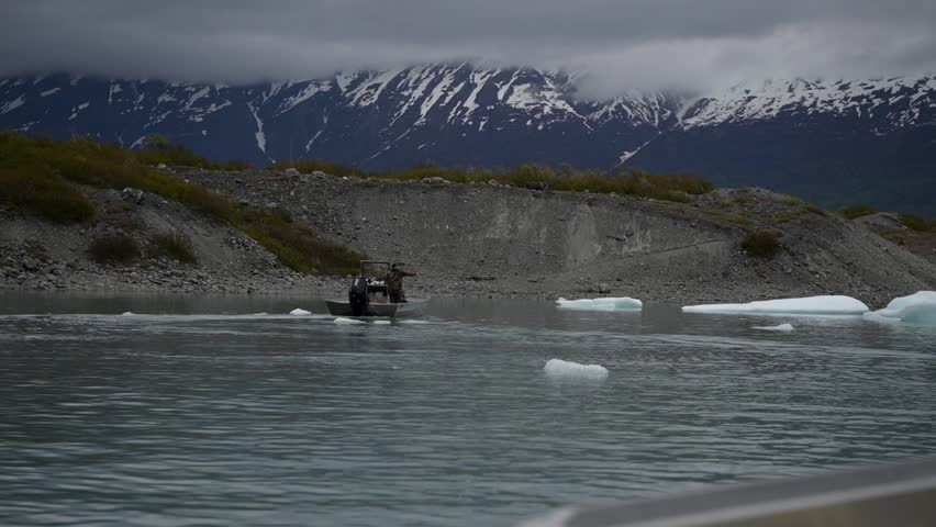 Cinematic handheld POV footage of a small boat navigating through ice chunks and icebergs on Matanuska Glacier in Alaska.  Ideal for dramatic, adventure, relaxing, travel, outdoor, and glacier-themed projects. 