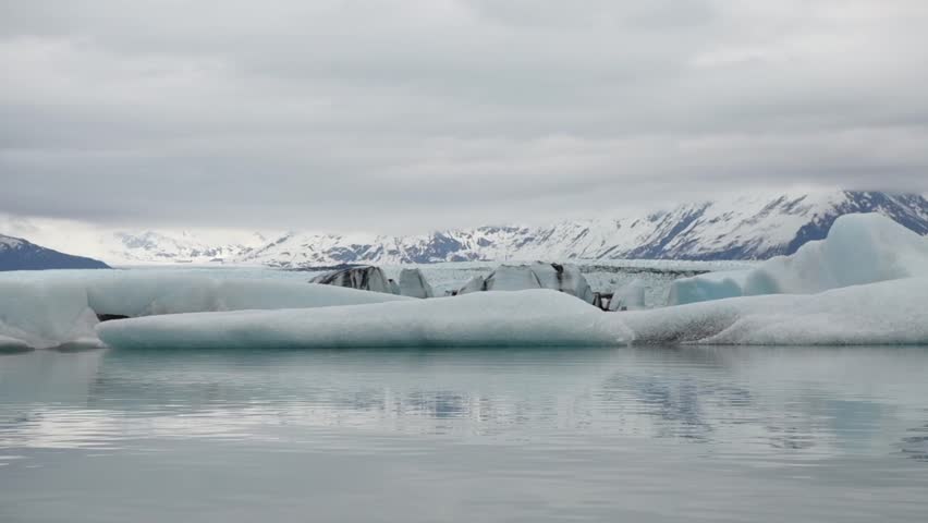 Cinematic handheld POV footage of a small boat navigating through ice chunks and icebergs on Matanuska Glacier in Alaska.  Ideal for dramatic, adventure, relaxing, travel, outdoor, and glacier-themed projects. 