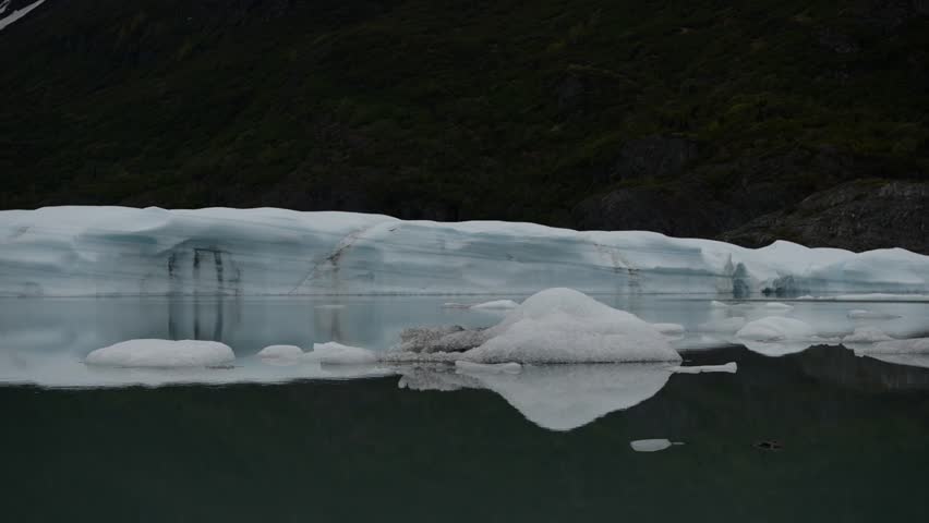 Cinematic handheld POV footage of a small boat navigating through ice chunks and icebergs on Matanuska Glacier in Alaska.  Ideal for dramatic, adventure, relaxing, travel, outdoor, and glacier-themed projects. 