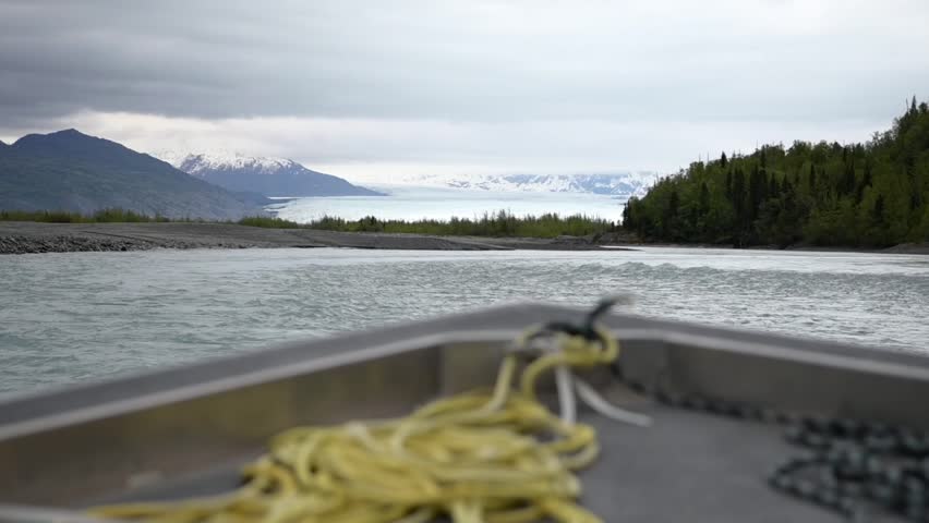 Slow motion cinematic handheld POV footage of a small boat navigating through ice chunks and icebergs on Matanuska Glacier in Alaska.  Ideal for dramatic, adventure, relaxing, travel, outdoor, and glacier-themed projects. 