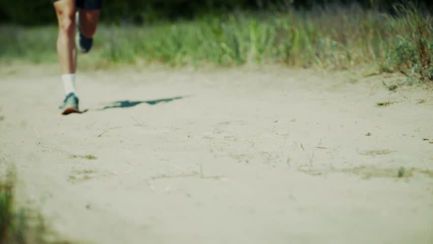 Professional Runner Training On Outdoor Road During Summer, Active Runner Exercising On Dusty Outdoor Road Path, Athletic Runner Jogging Along Rural Outdoor Road Way, Sports Performance In Natural Environment, Healthy Lifestyle And Physical Activity, Morning Workout In Green Meadow, Cardio Training For Endurance Goals, Sprint Motion In Countryside Landscape, Fitness Routine Under Sunlight, Daily Exercise For Body Health