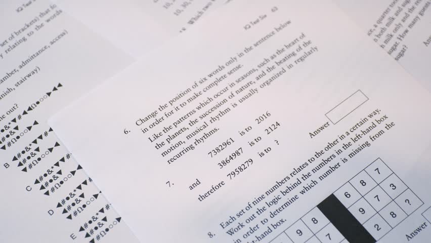 Student Hand Filling Out Multiple Choice Test Sheet, School Exam or Assessment Close-Up. IQ test