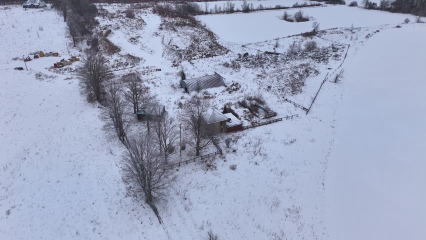 Decayed And Forgotten Stone Homestead Surrounded By A Frozen Rural Landscape, Orbiting Aerial Shot.