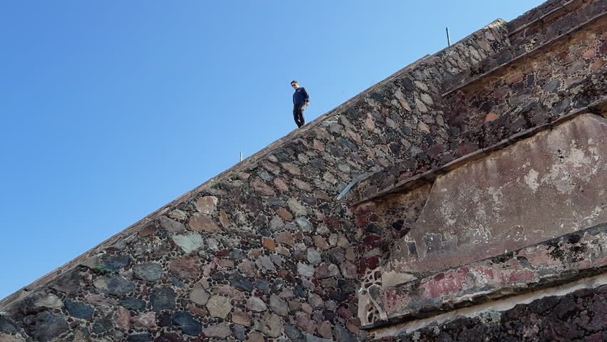A man descends the stairs at the Teotihuacan pyramid, also called the Pyramid of the Sun, Mexico