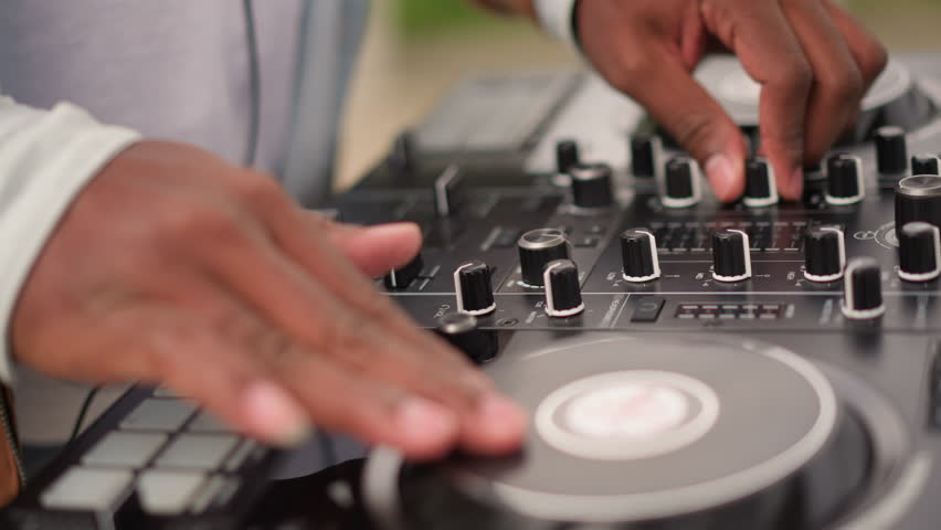 Energetic outdoor DJ performance, Dynamic DJ spinning colorful rhythmic melodies live outdoors, Vivid musical act with hands expertly controlling turntables at energetic openair festival