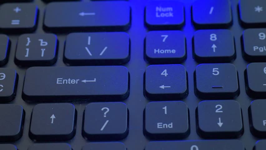 Cinematic keyboard teardown under colored light showing multiple missing keys and exposed stabilizers, tool moving across numpad area, empty sockets and beginning of cleanup,