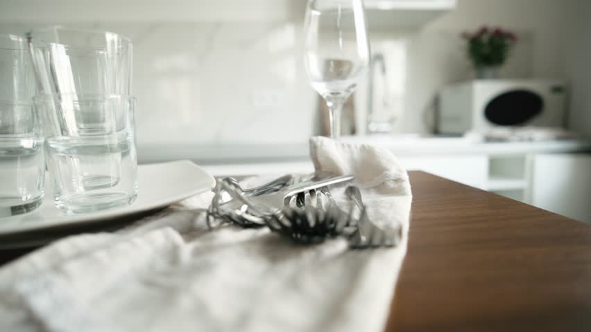 Clean Dishes And Glasses Drying On A Kitchen Table After Hand Washing