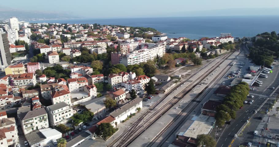 Aerial view of the city of Split, with its old and modern buildings, the railway tracks with the blue of the Adriatic and the docks, ferries, cars on a sunny summer day full of tranquility, Split, Cro