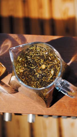 Herbal tea in a teapot. tea drink. close-up. top view. three glass teapots with different herbal, colorful tea. leafy floral, crushed mint, lime, linden and chamomile tea.